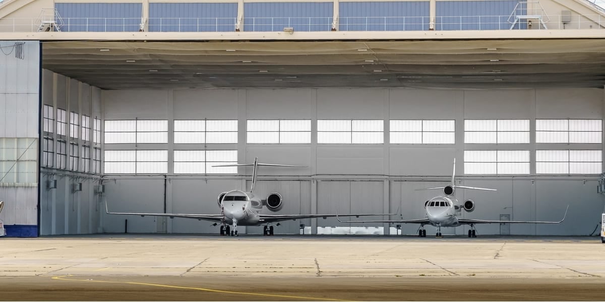 two aeroplanes parked in a hangar