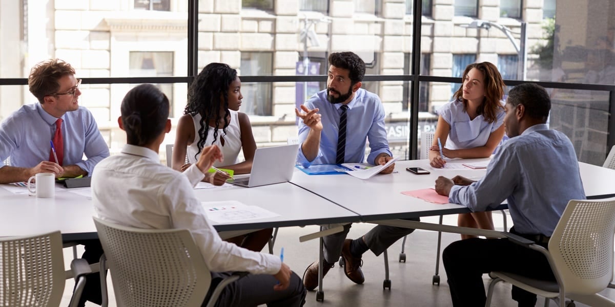 people having a meeting round a table