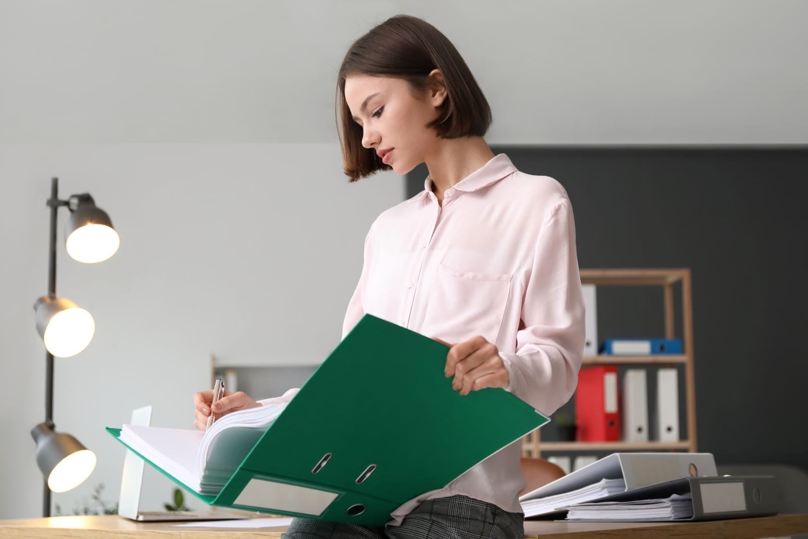 woman writing in folder