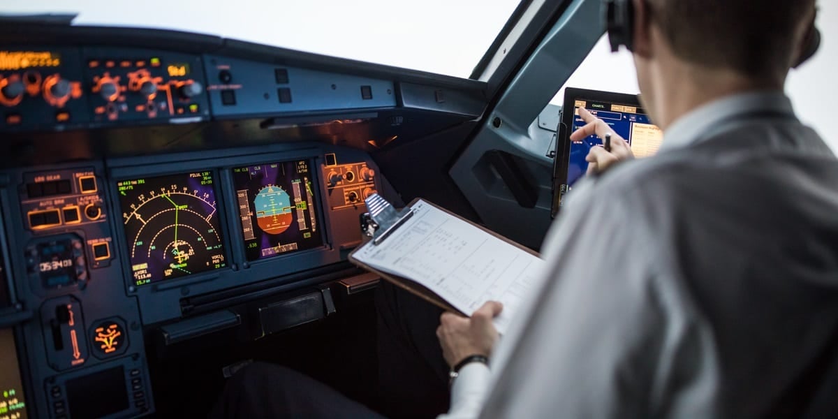 pilot in cockpit doing an assessment